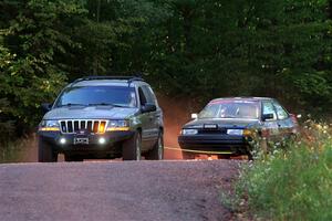A Jeep Grand Cherokee sweeps the Joe Boburka / Elizabeth Unglenieks-Ploeg Ford Escort from SS5, Norway South II.