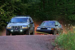 A Jeep Grand Cherokee sweeps the Joe Boburka / Elizabeth Unglenieks-Ploeg Ford Escort from SS5, Norway South II.