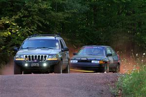 A Jeep Grand Cherokee sweeps the Joe Boburka / Elizabeth Unglenieks-Ploeg Ford Escort from SS5, Norway South II.