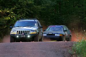A Jeep Grand Cherokee sweeps the Joe Boburka / Elizabeth Unglenieks-Ploeg Ford Escort from SS5, Norway South II.