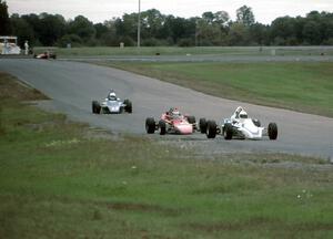 Three Formula Fords and a Continental stream from turn 6 into 7.