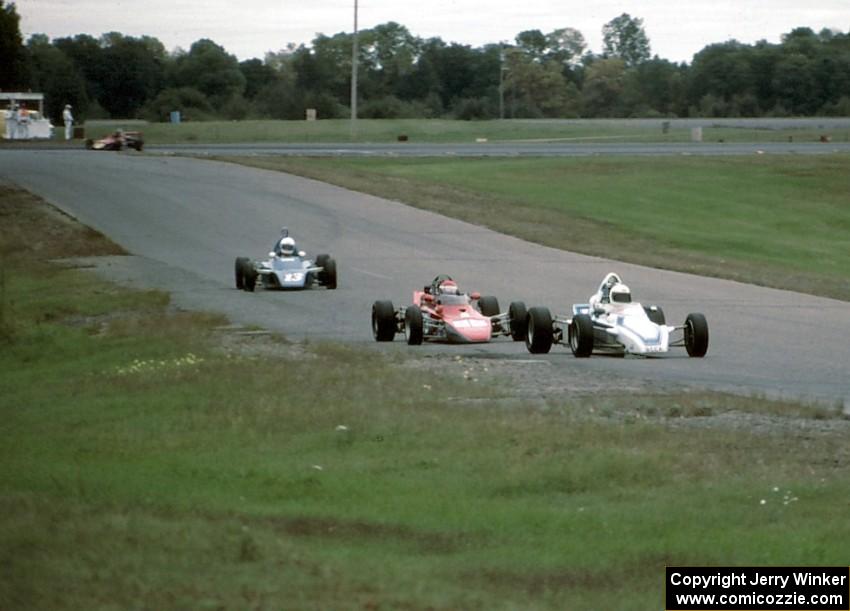 Three Formula Fords and a Continental stream from turn 6 into 7.