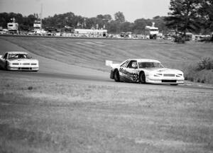 John Jones leads Roush Mercury Capri teammate Chris Kneifel through turn 7.