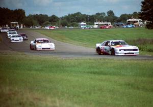 The field streams through turns 6 and 7 on lap one.