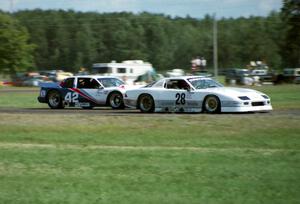 Jim Miller's Chevy Camaro holds off Tommy Riggins's Buick Somerset Regal headed into turn five.