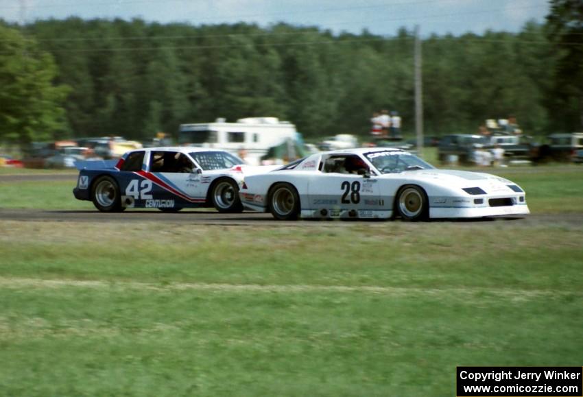 Jim Miller's Chevy Camaro holds off Tommy Riggins's Buick Somerset Regal headed into turn five.