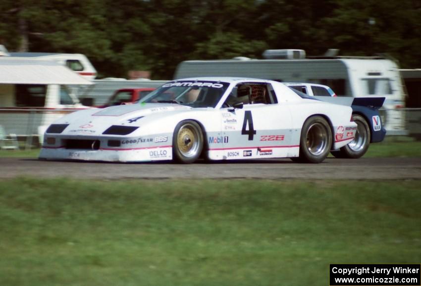 Wally Dallenbach, Jr.'s Chevy Camaro and Tommy Riggins's Buick Somerset Regal go side-by-side into turn ten.