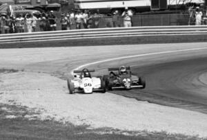 Steve Bren's Ralt RT-5/86 forces Didier Theys's Martini Mk.50 off turn five on the second to last lap.