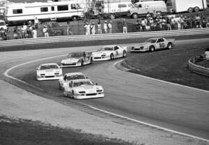 The field streams through turn 5 on lap one of Saturday's qualifying race.