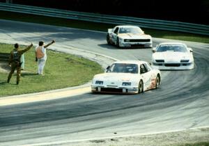 The top three come through canada Corner on the cool-off lap.