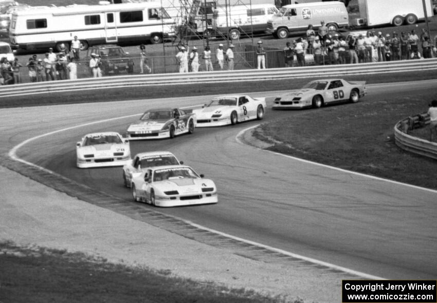 The field streams through turn 5 on lap one of Saturday's qualifying race.