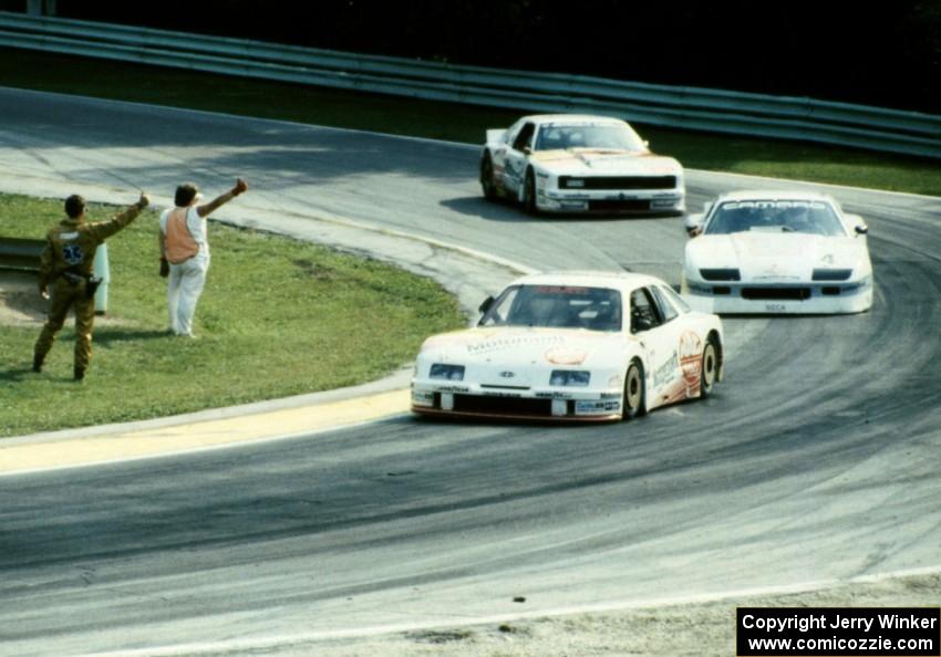 The top three come through canada Corner on the cool-off lap.