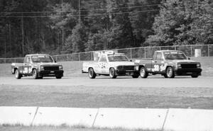Bobby Archer's Jeep Comanche leads Steve Lewis' Toyota Pickup and Tommy Archer's Jeep Comanche during the race.