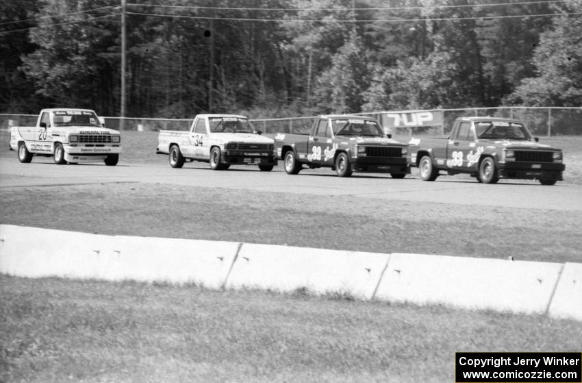 Tommy and Bobby Archer's Jeep Comanches hold off Steve Lewis' Toyota Pickup and Tim Evans' Ford Ranger during the race.