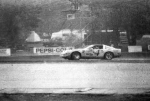 The Bobby Archer / Tommy Archer Chevy Corvette spins at turn ten while leading in the rain.