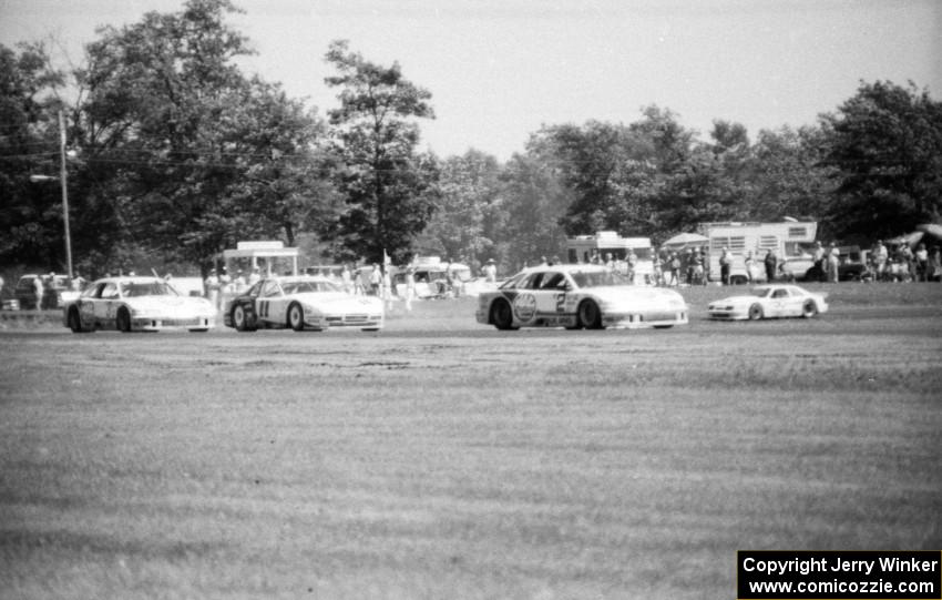 Scott Pruett's Merkur XR4Ti, Elliott Forbes-Robinson's Porsche 944 Turbo and Pete Halsmer's Merkur XR4Ti run nose-to-tail.