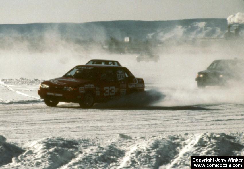 Tommy Archer / Bobby Archer Chevy Spectrum Turbo chased by the Chris Menard / Jon Kurshinsky Dodge Omni GLH-S on lap one.