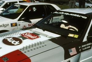 Clark Bond sits in the passenger seat of Bruno Kreibich's Audi Quattro reviewing notes before the start.