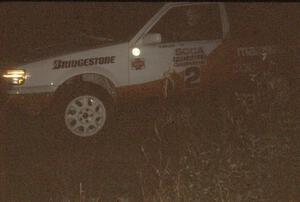 Rod Millen / Harry Ward in their Gr. A Mazda 323 GTX at night.