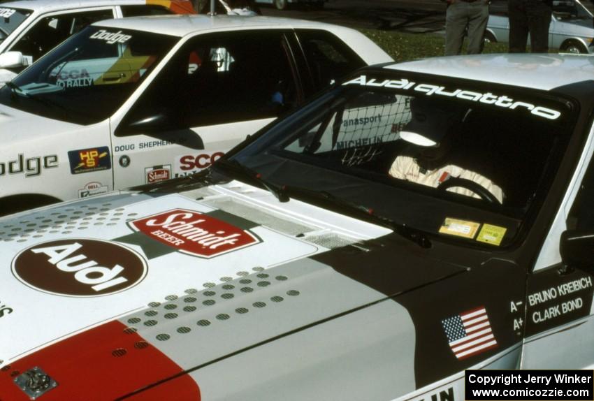 Clark Bond sits in the passenger seat of Bruno Kreibich's Audi Quattro reviewing notes before the start.