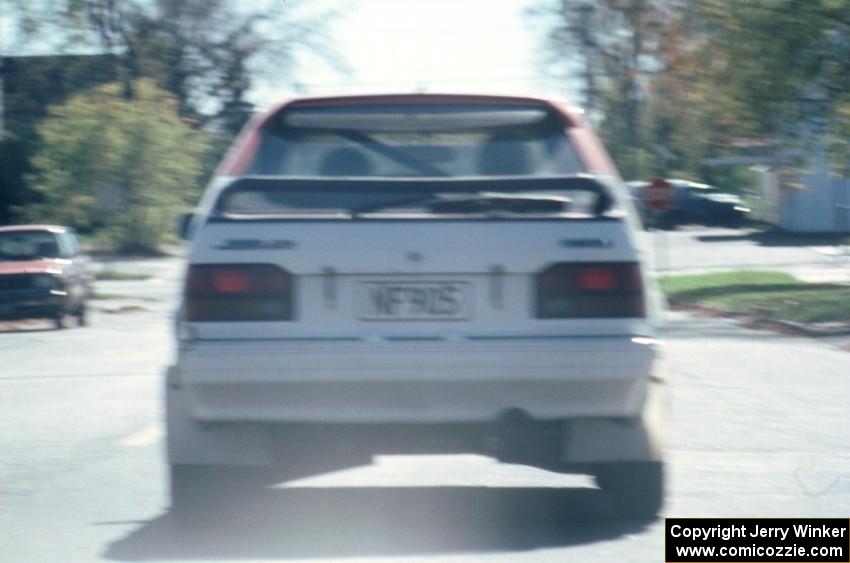 Rod Millen / Harry Ward in their Gr. A Mazda 323GTX in transit to SS2.