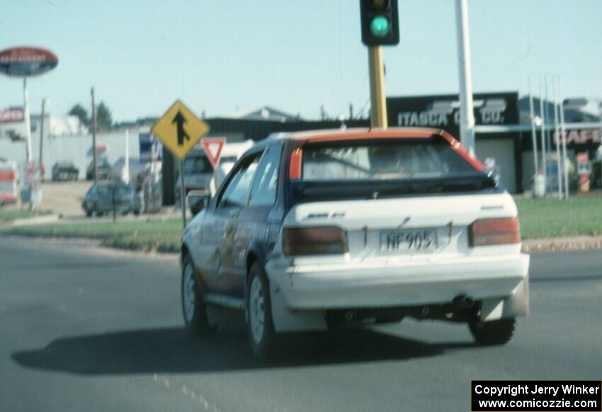 Rod Millen / Harry Ward in their Gr. A Mazda 323GTX in transit to SS2.