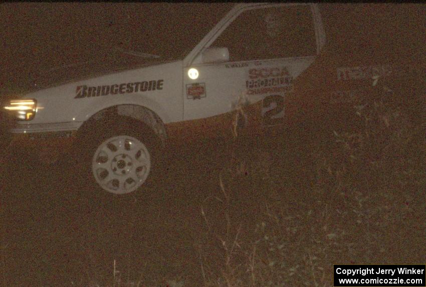 Rod Millen / Harry Ward in their Gr. A Mazda 323 GTX at night.