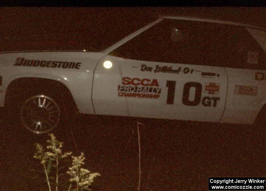 Dan Gilliland / Betty-Ann Gilliland in their Dodge Shelby at night.