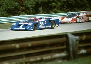 Elliott Forbes-Robinson / Geoff Brabham Nissan GTP ZX-T passes the James King / Howard Cherry Fabcar CL/Porsche (Lights)