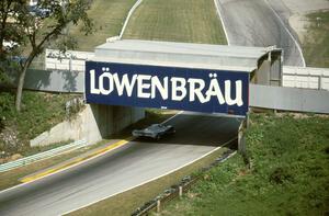 Al Holbert / Al Unser, Jr. Porsche 962 heads under the Billy Mitchell Bridge at turn 13.