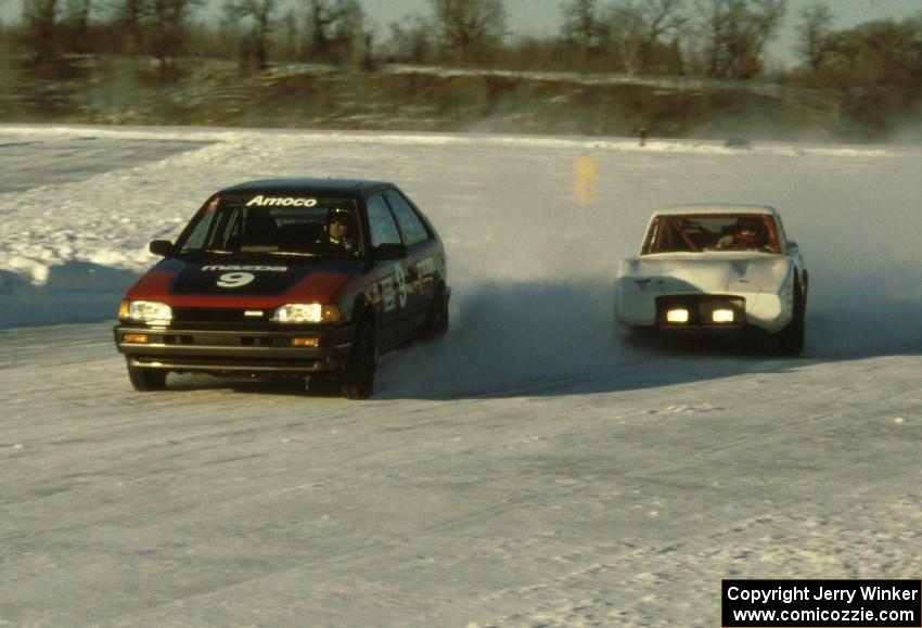 Lee Wuesthoff's Mazda 323GTX and Leighton Reese's Mazda Wankel-powered SAAB Sonnet III battle on lap one