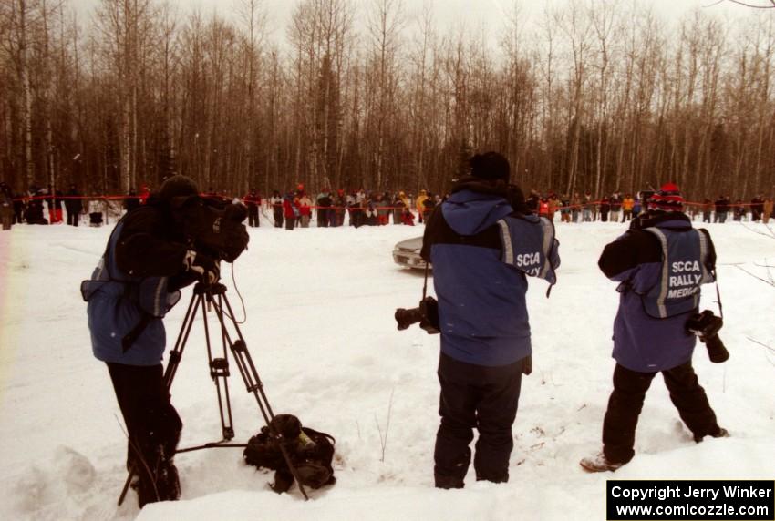 A Speed Channel cameraman, Tom McKinney and Morgan Segal pan as the Russ Hodges / Mike Rossey Subaru WRX passes by on SS12