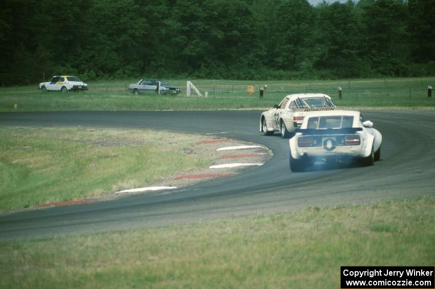 Glen Brown's Mazda RX-7 and Bill Cammack's Datsun 280Z battle for the C Production win in turn 4.