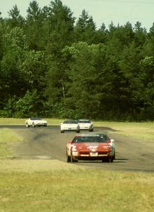 Bill Cooper chased by a number of unidentified DR Motorsports Chevy Corvettes