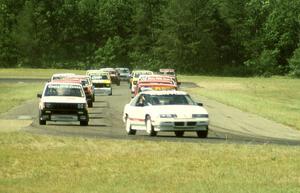 The field follows the pace car into turn 4.
