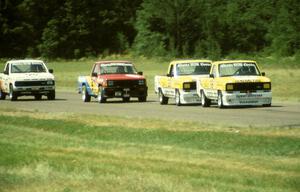 Steve Saleen's and George Follmer's Ford Rangers lead Peter Farrell's Dodge Ram D-50 and Chuck Hemmingson's Jeep Comanche into 4