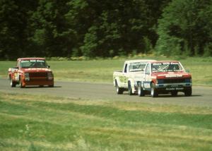 Spencer Low's Nissan Pickup leads David Diedrick's Jeep Comanche and Mitch Wright's Jeep Comanche