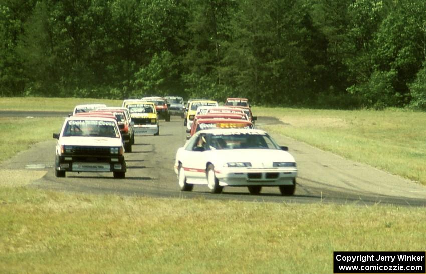 The field follows the pace car into turn 4.
