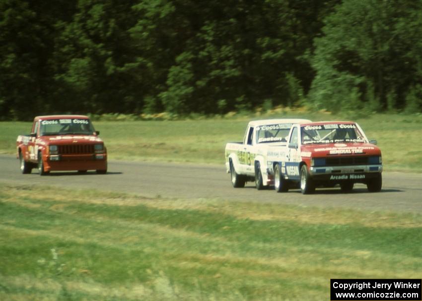 Spencer Low's Nissan Pickup leads David Diedrick's Jeep Comanche and Mitch Wright's Jeep Comanche