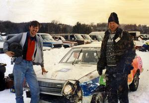 Paul Richardson  and Jerry Winker stand in front of their slightly battered Mazda GLC