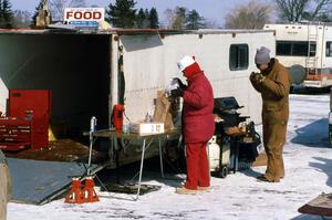 Grilling on the ice. Jeff Ruzich samples the goods.