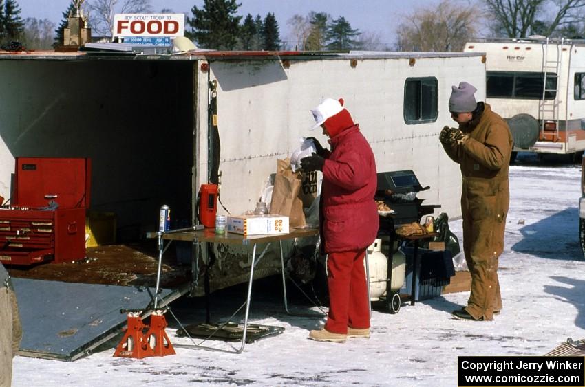 Grilling on the ice. Jeff Ruzich samples the goods.