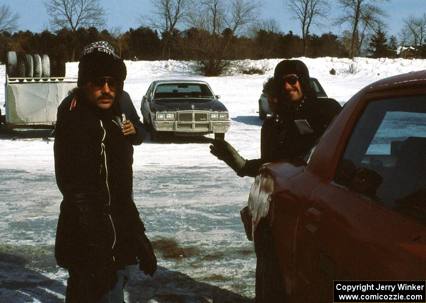 Dave Neujahr and Tony Roggemann and crew relax by their RX-7 after the race is cancelled.