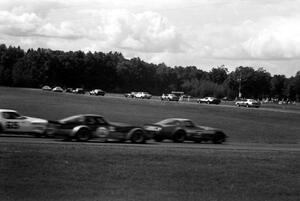 The field streams through turns 4 and 5 on the first lap.