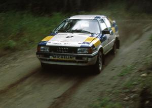 Paul Choiniere / Doug Nerber fly down a straight in the Paul Bunyan forest in their Audi Quattro.