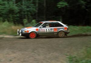 Jeff Zwart / Cal Coatsworth in their Mazda 323GTX at a hairpin.