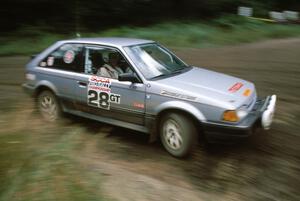 Allan George / Gary Judy fly by in their PGT class Mazda 323GTX running in Group A.