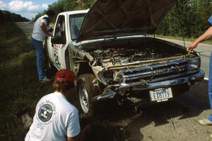 Rusty Campbell / John McArthur survey damage to their Toyota Pickup. Unfortunately they were unable to restart.