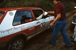 Dick Corley / Tom Grimshaw get their time card handed to them by Pete Connors. Note the sponsor on their VW GTI!