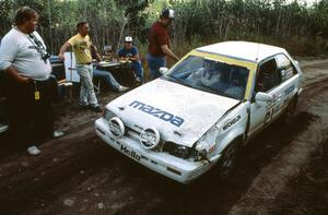 Jeremy Shaw / Keith Waltz check into the finish of the stage in their Mazda 323GTX. They retired shortly after.